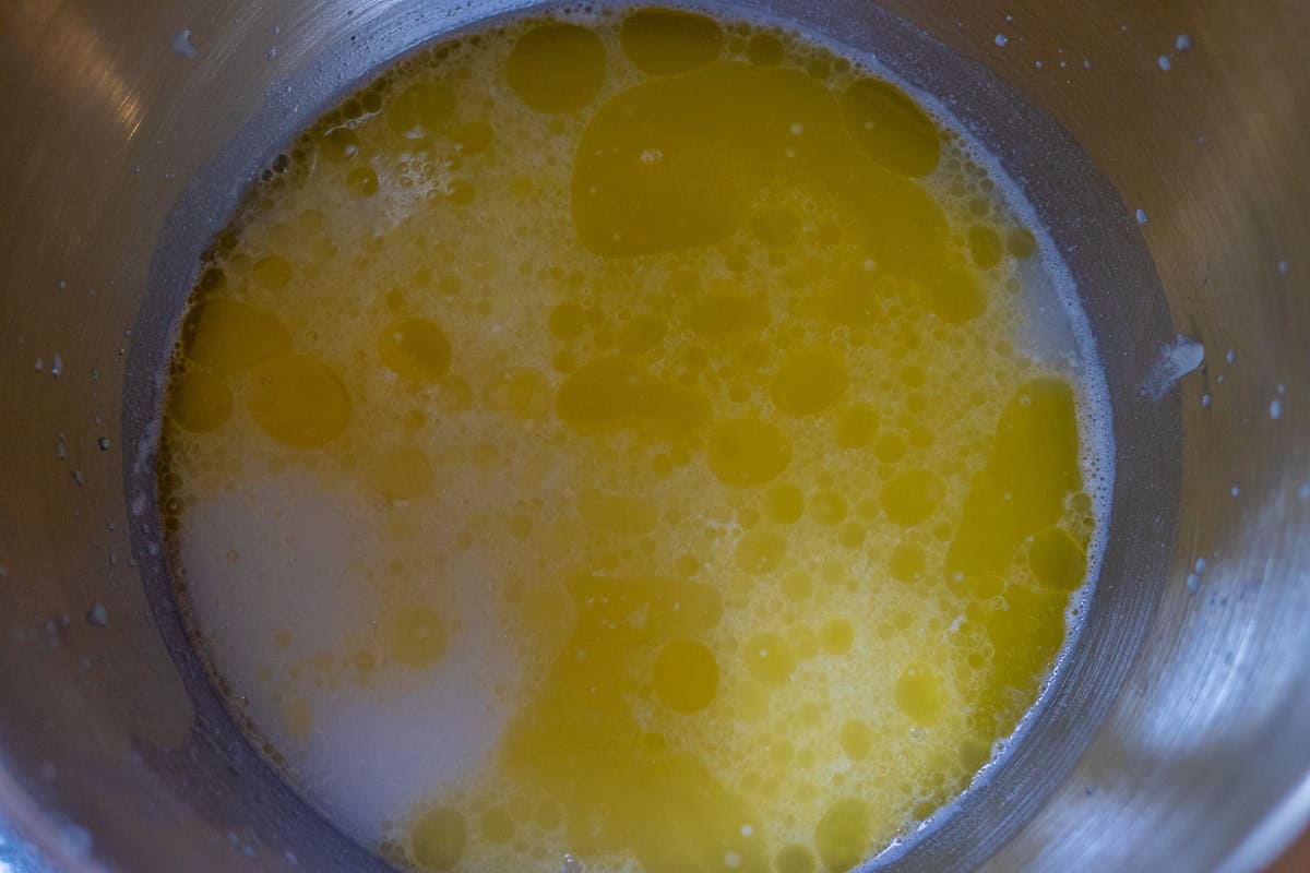 Melted butter is added to sourdough starter and water mixture.