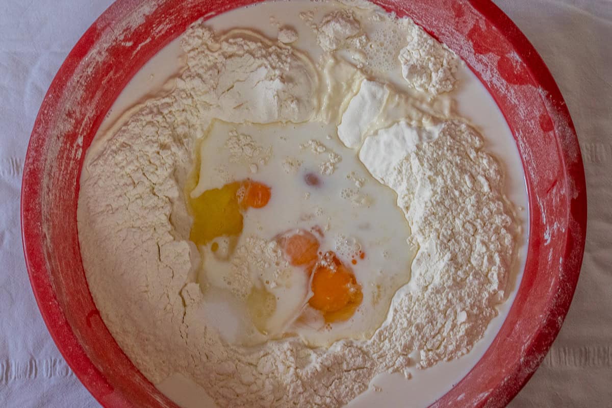 flour, eggs, milk, water, and salt are placed in a large bowl