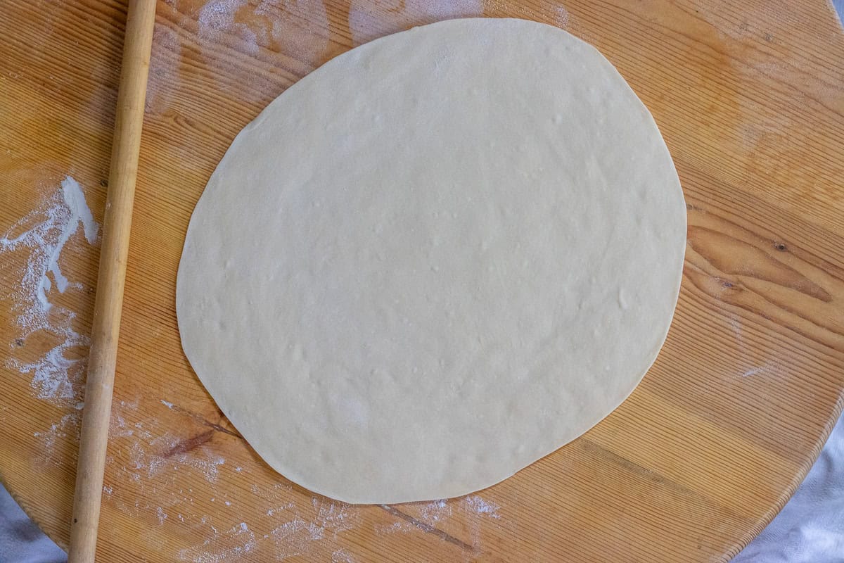 one dough ball rolled out into a circle