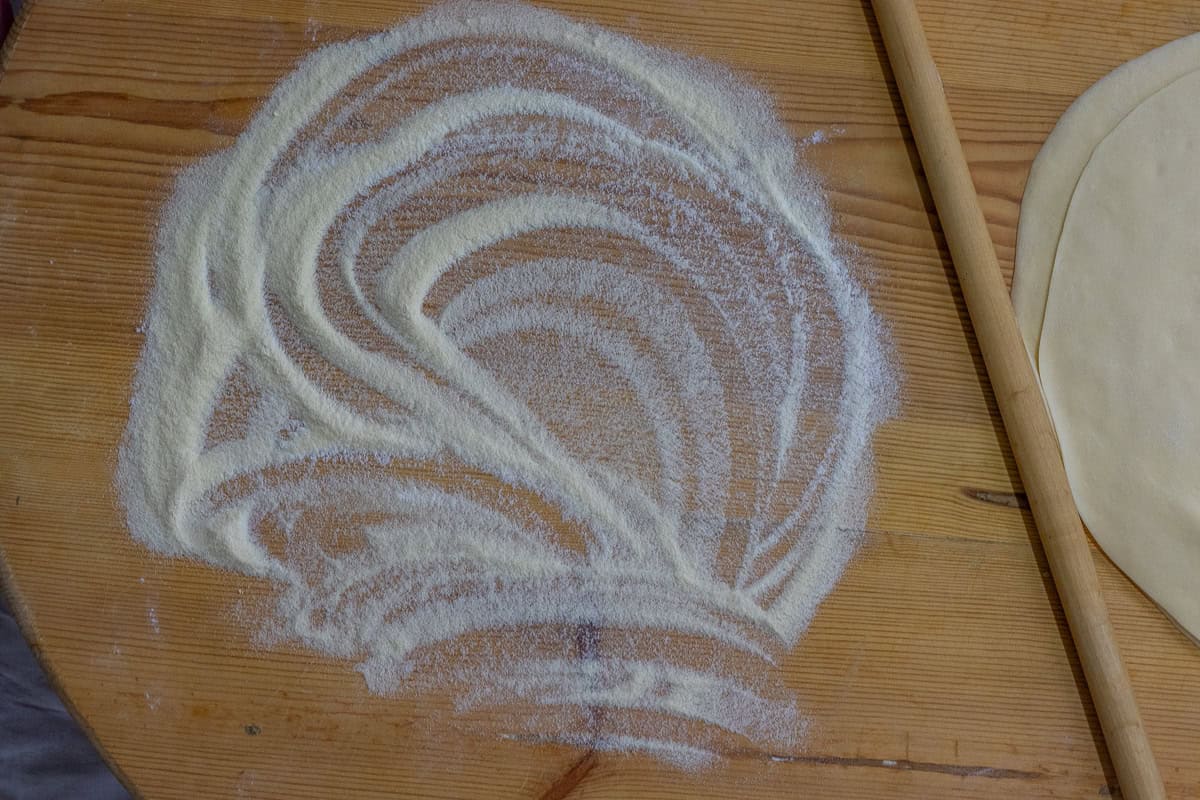 worktop is generously dusted with semolina and flour mixture