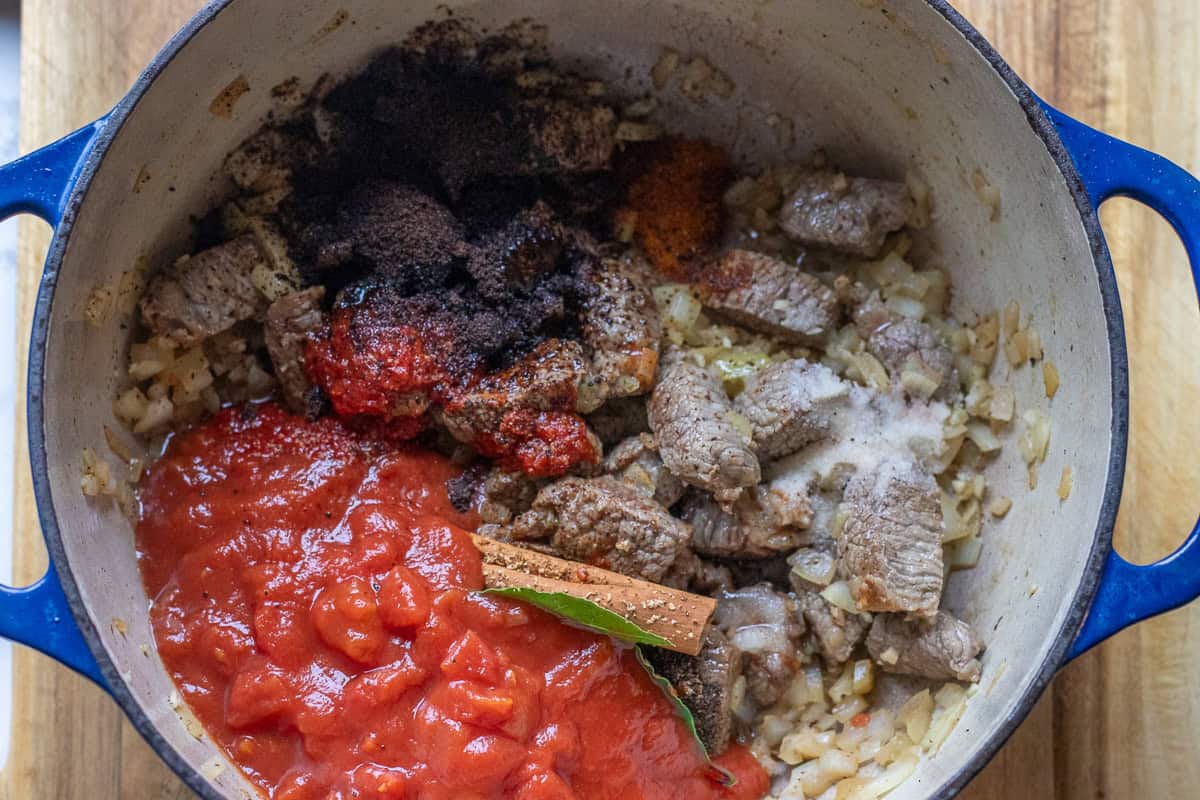 tomatoes, tomato paste, seasoning and flavourings are added to the pan