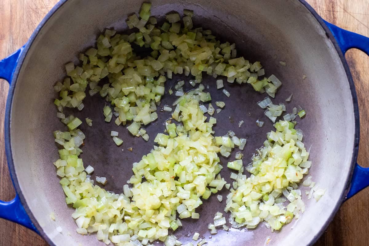 Sautéing onions and celery with olive oil.
