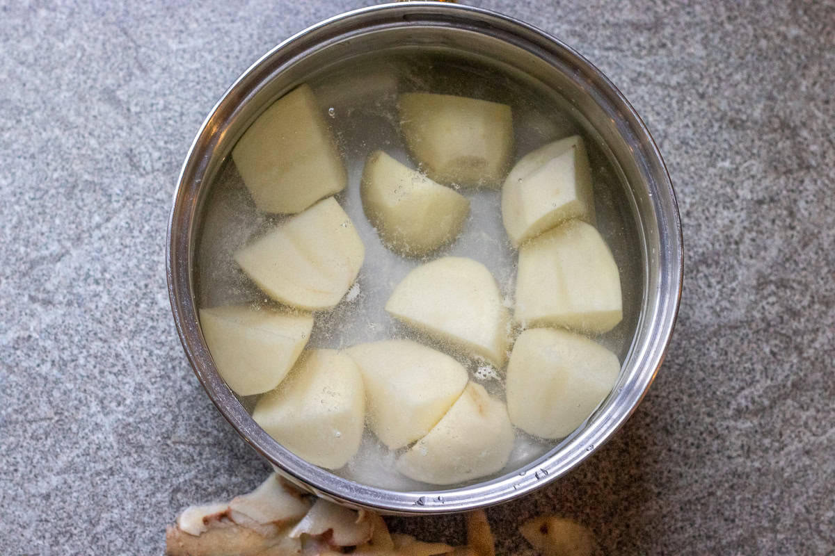 peeled and cut potatoes are placed in a pan with water
