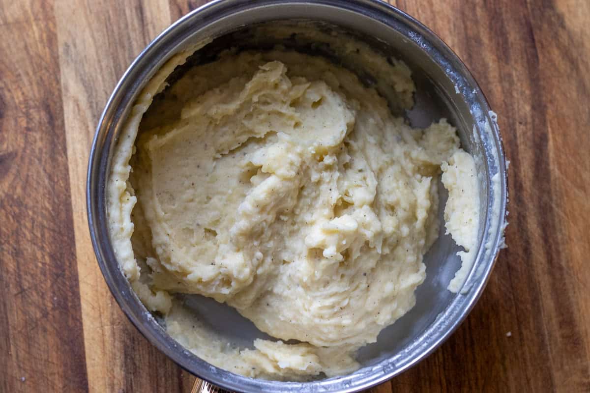 cooked potatoes are turned into a mash