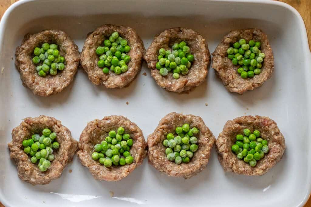 meatballs are topped with mashed potatoes