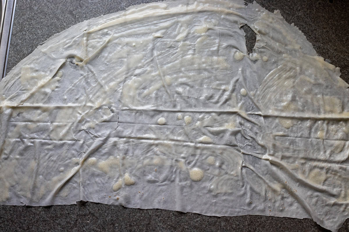 half yufka sheet covered with sauce