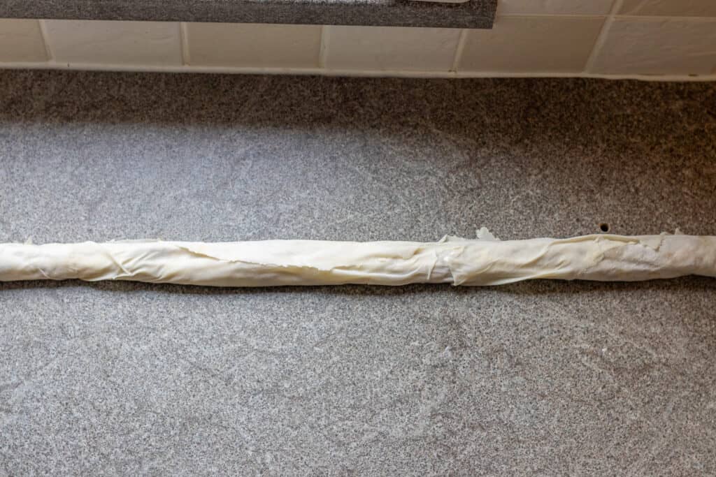 yufka sheet rolled into a log shape