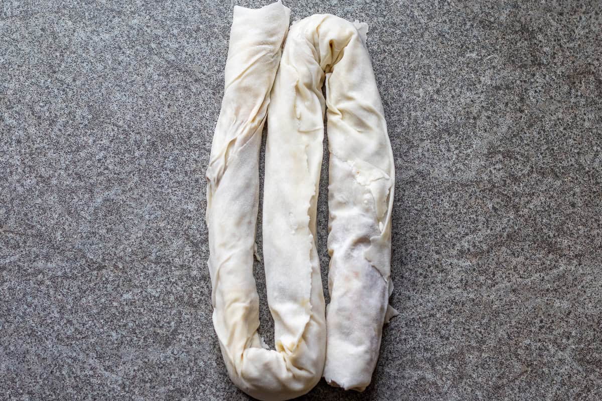 filled pastry is shaped into an arm