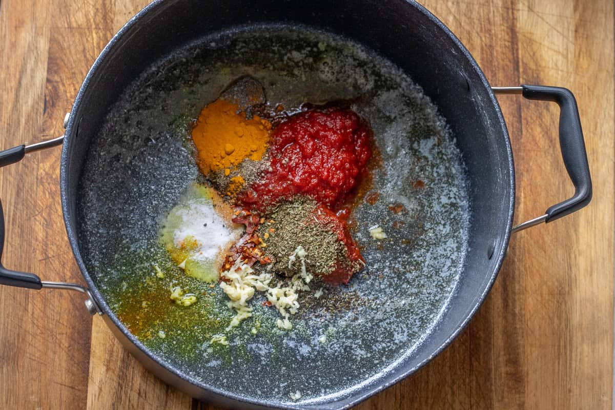 melted butter, tomato paste, red pepper paste, and seasoning are added to the pot