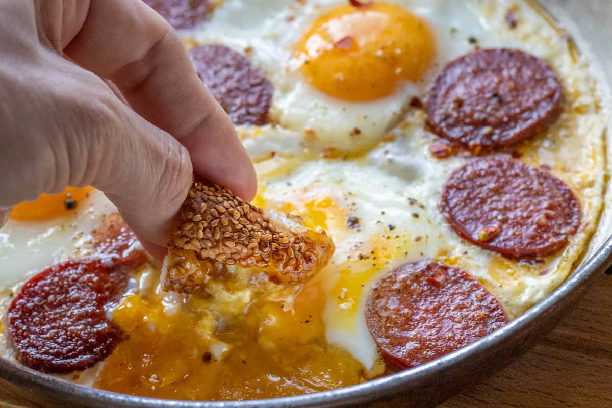 dipping Simit bread in egg yolk