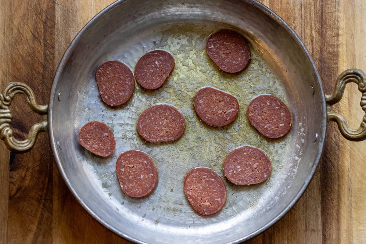 sucuk slices are placed in a saran with butter