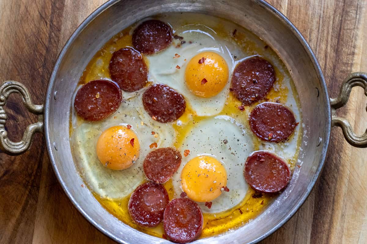 3 eggs are cracked into sahan