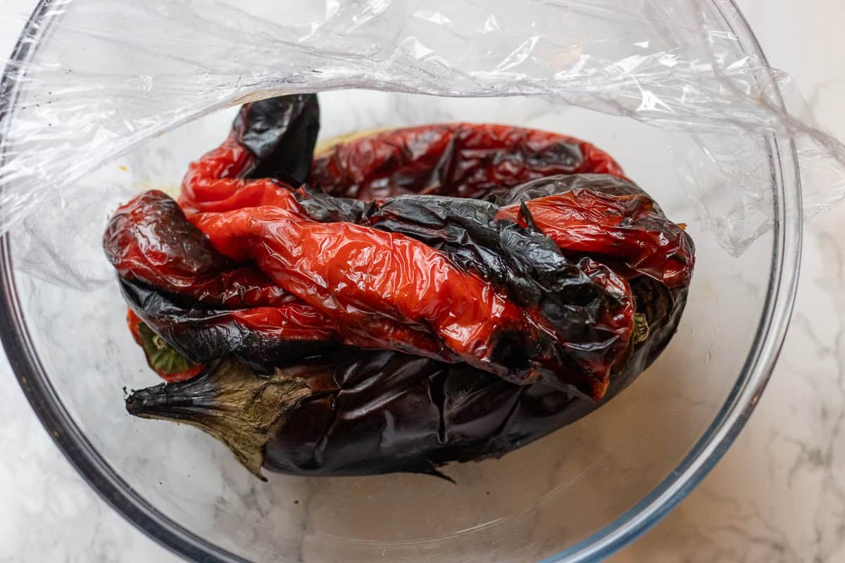 roasted red peppers and eggplant are placed in a bowl