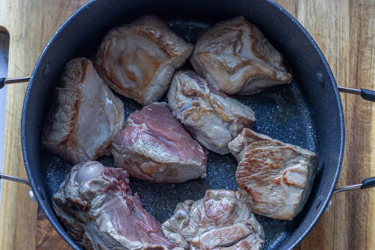 browning the lamb pieces in a pan