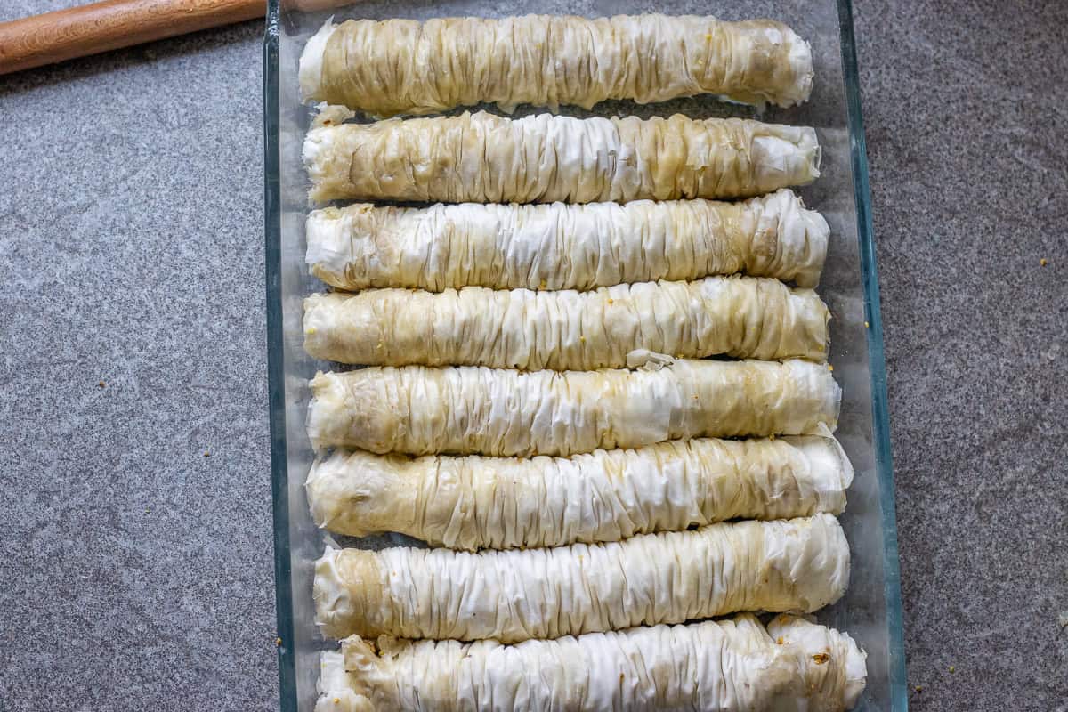 baklava rolls are placed in baking dish