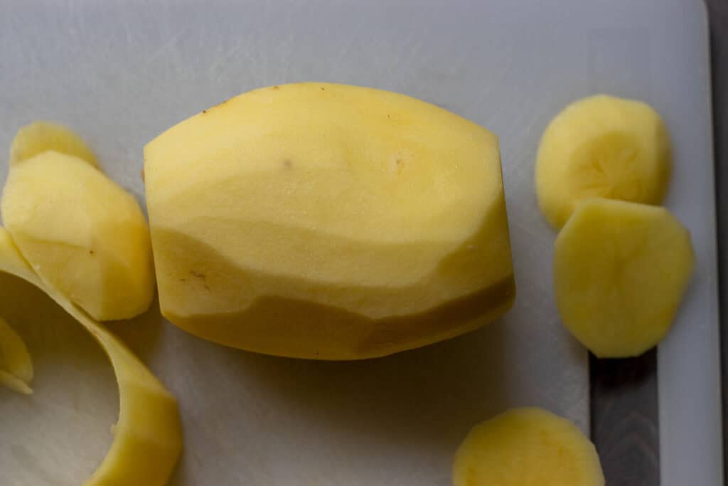 trimmed potato is cut in half
