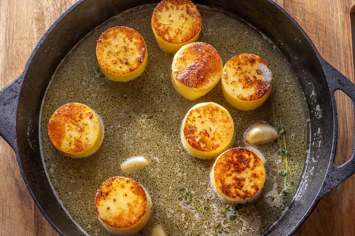 chicken stock is poured in skillet