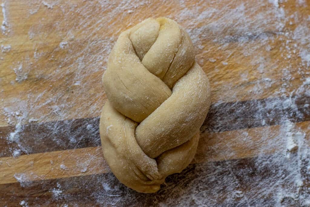 3 pieces of dough braided to shape paskalya coregi