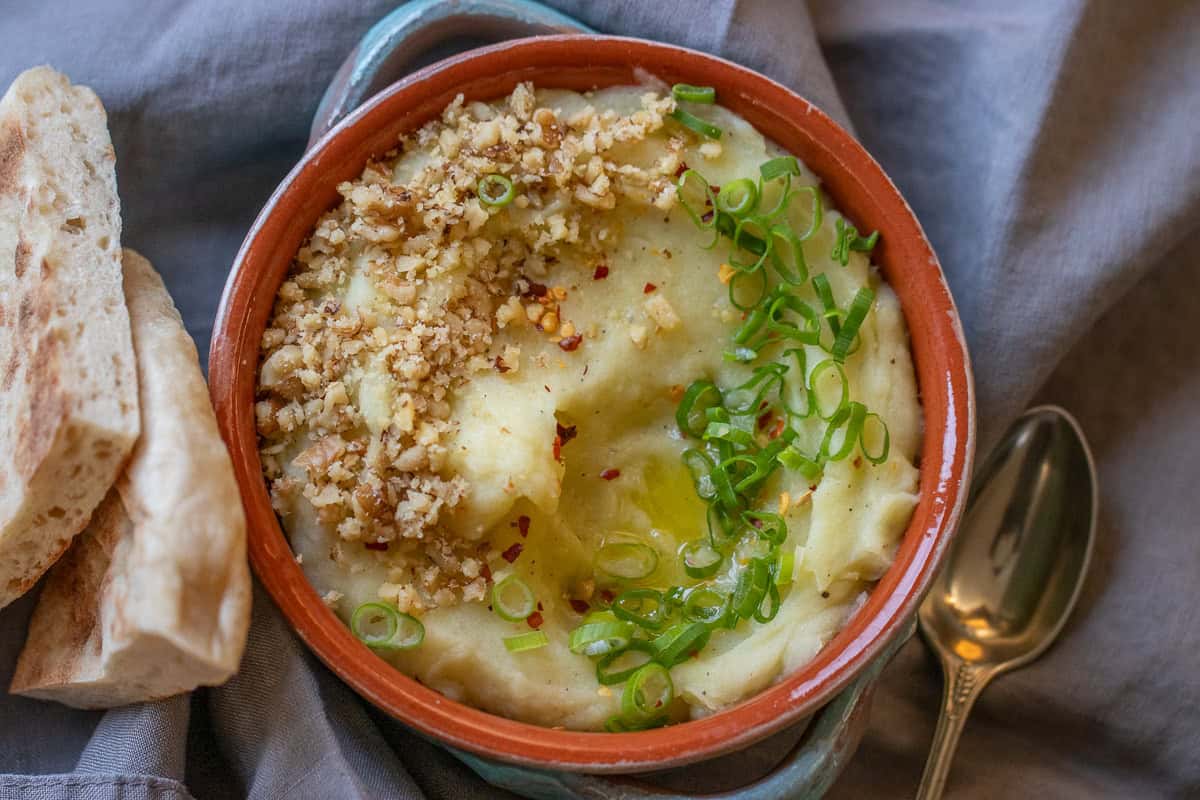 skordalia garnished with spring onions and served with flatbread