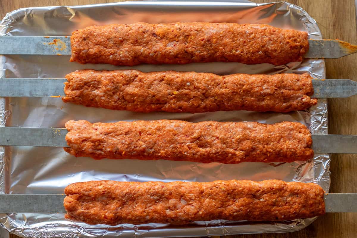 urfa kebab mixture is divided into 4 skewers