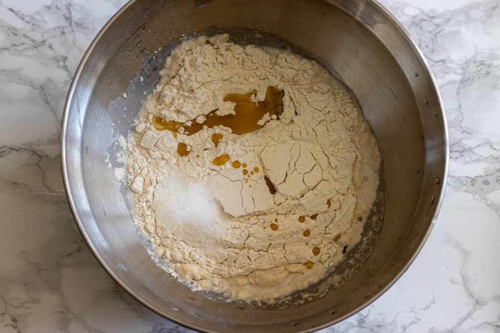 ingredients for biberli ekmek dough are placed in a large bowl