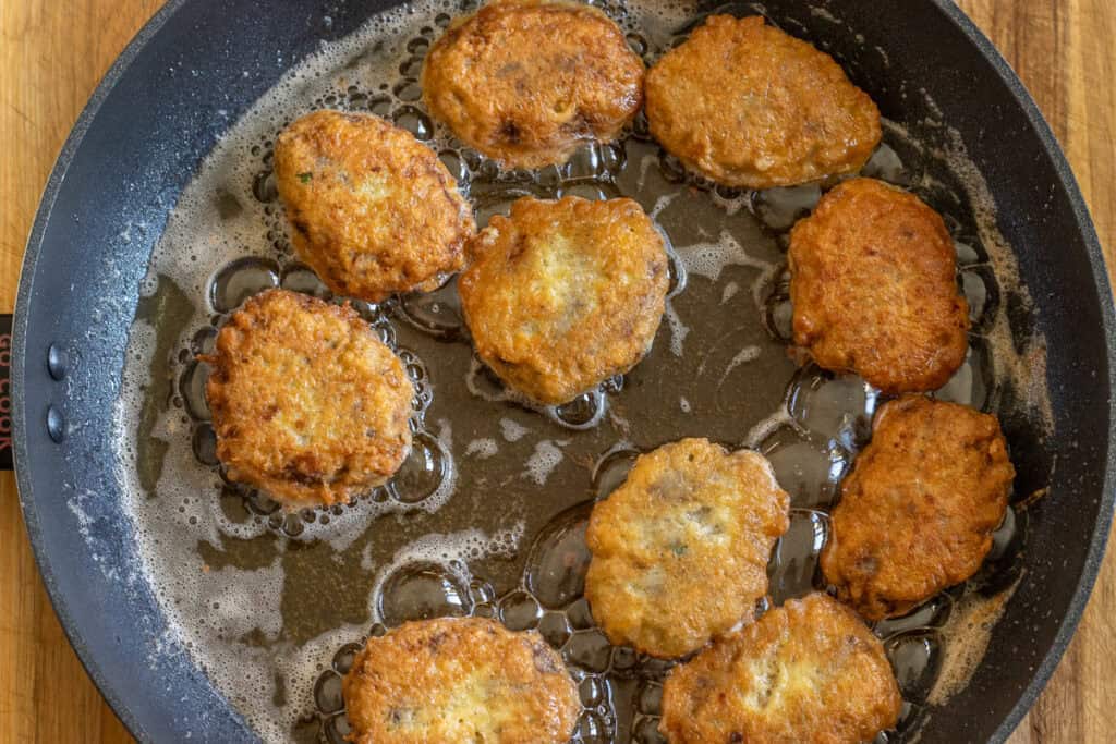 frying the meatballs in oil until golden