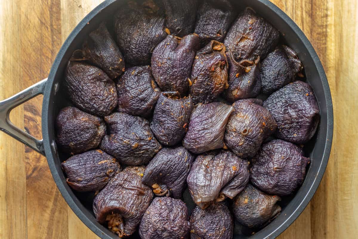 stuffed dried eggplants are place in a pan