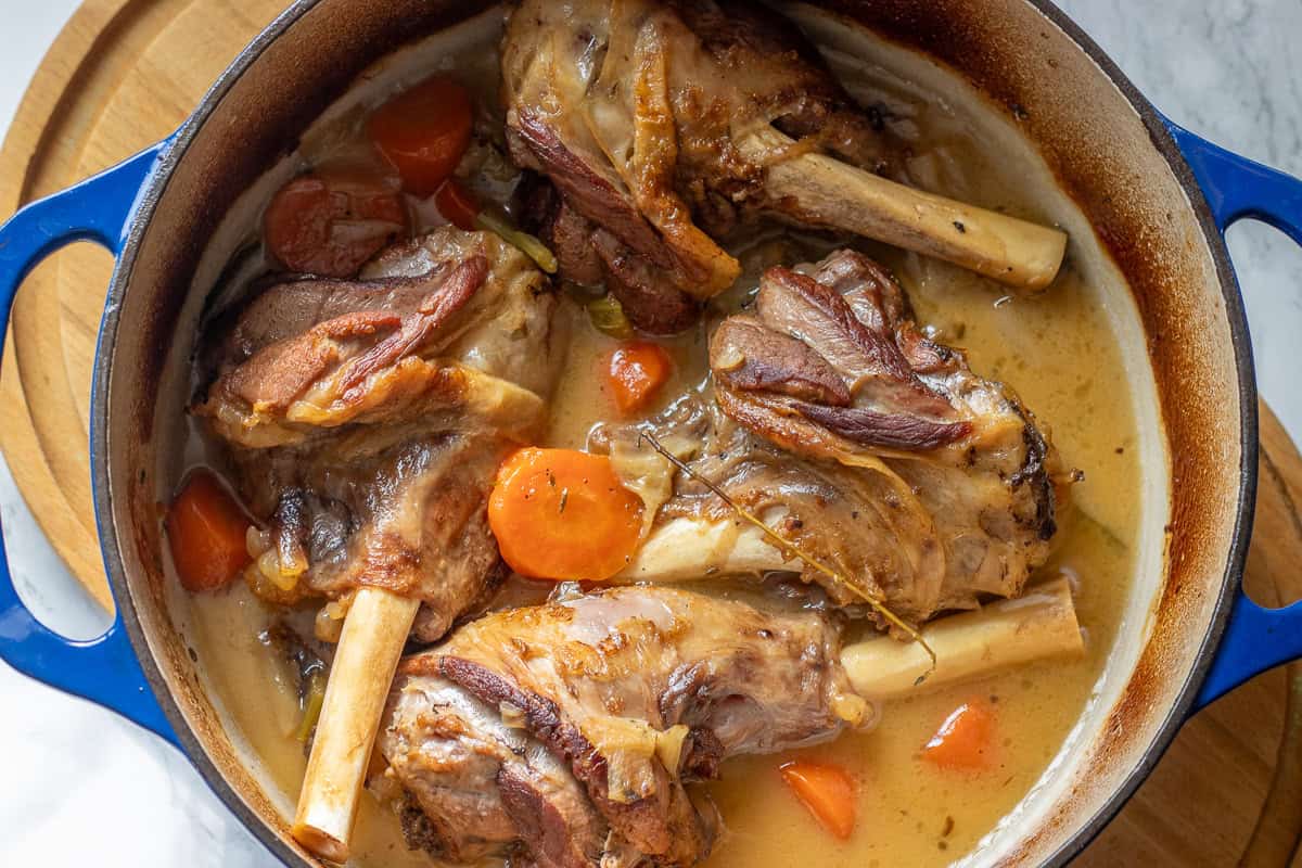 lamb shanks are cooked in broth until fell off the bone