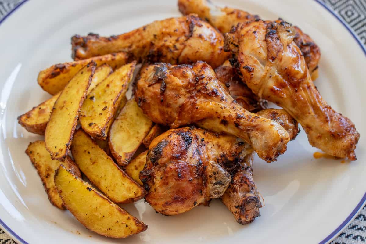 air fried chicken legs and potatoes on a plate