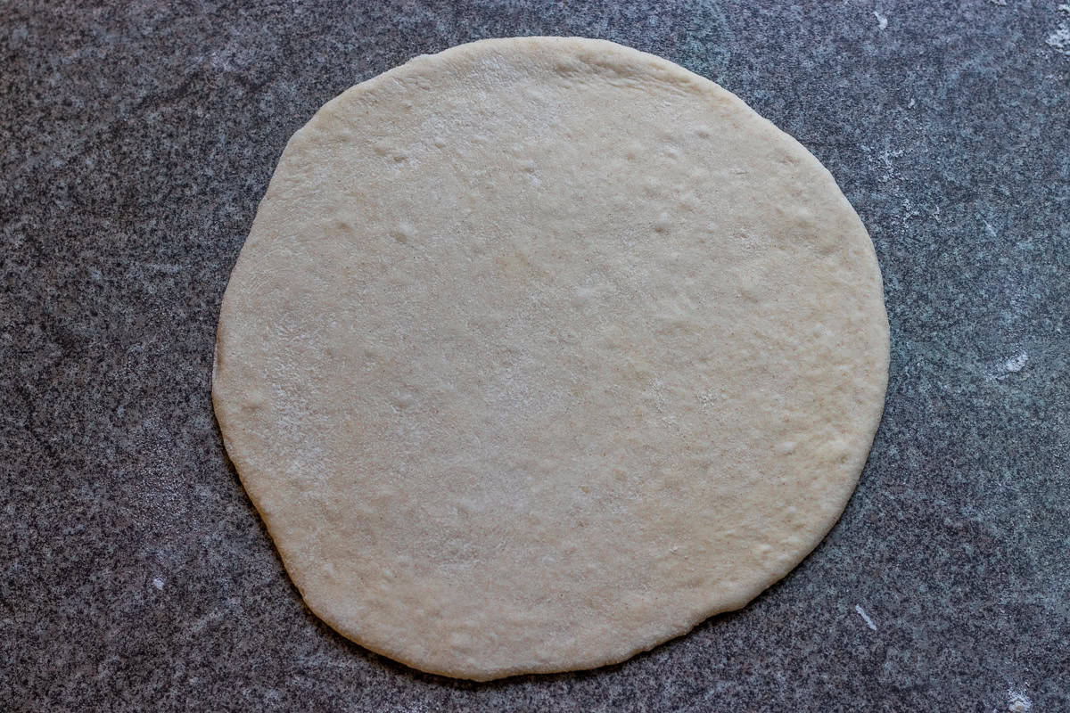 a dough ball for laffa rolled out into a circle