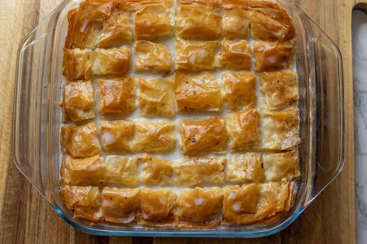 cold baklava is soaked in milk syrup