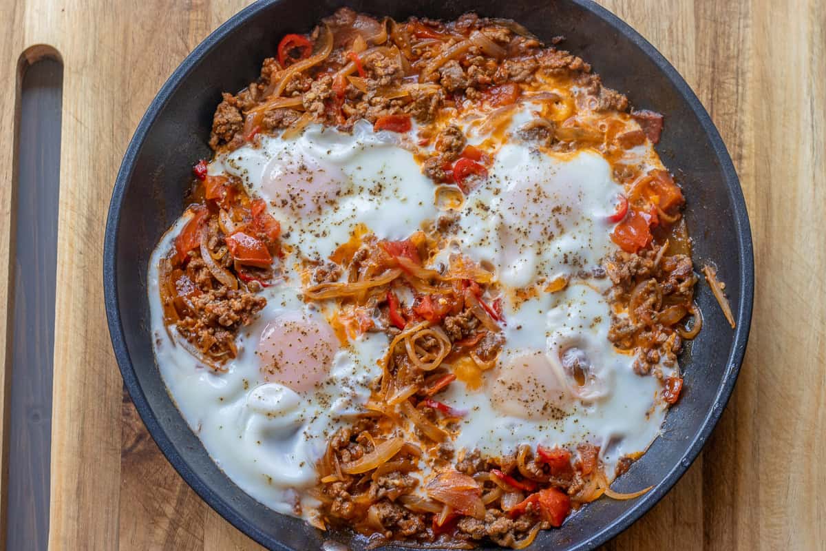 ground beef and eggs dish in a pan
