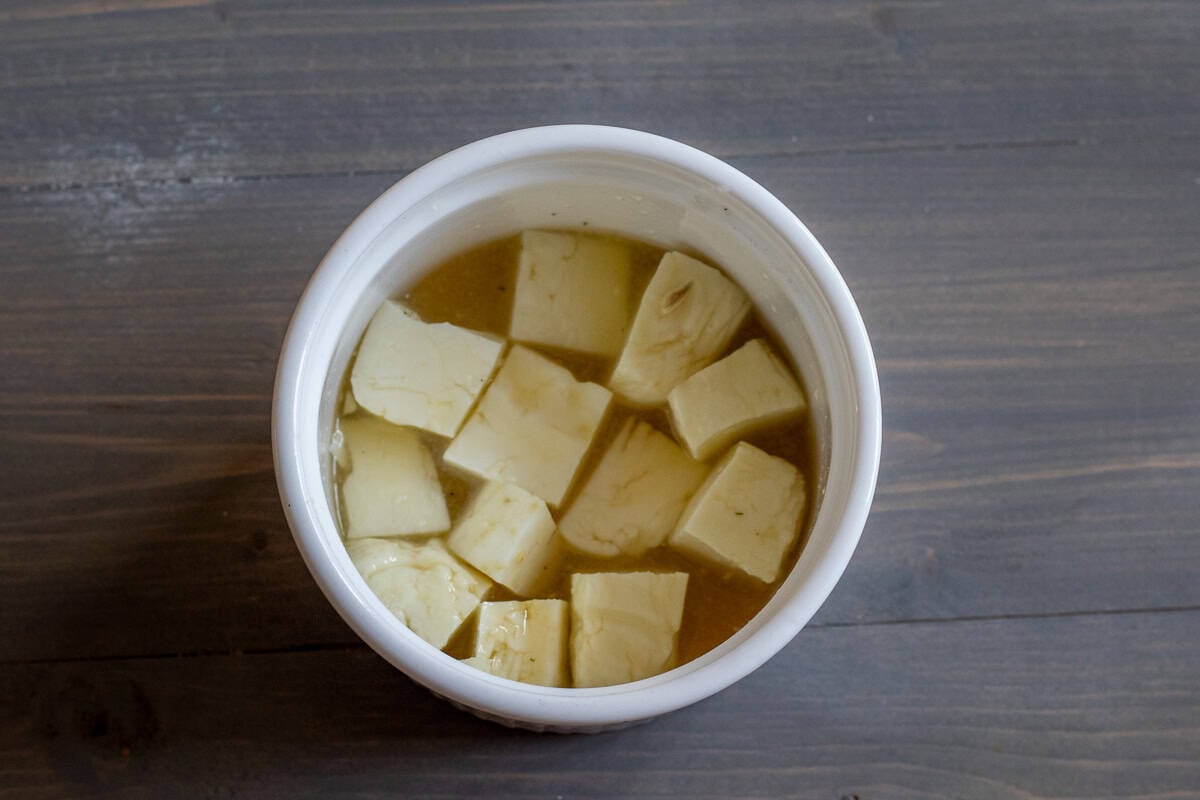 halloumi cubes marinating in honey and lemon juice