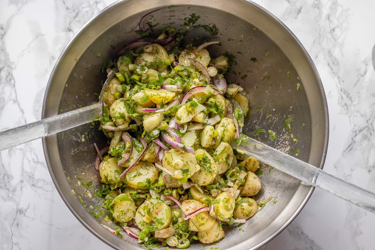 potato salad ingredients are tossed together