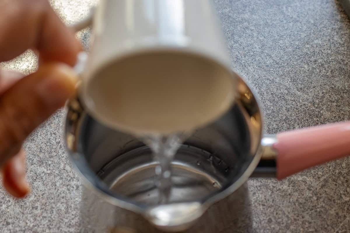 pouring water into cezve