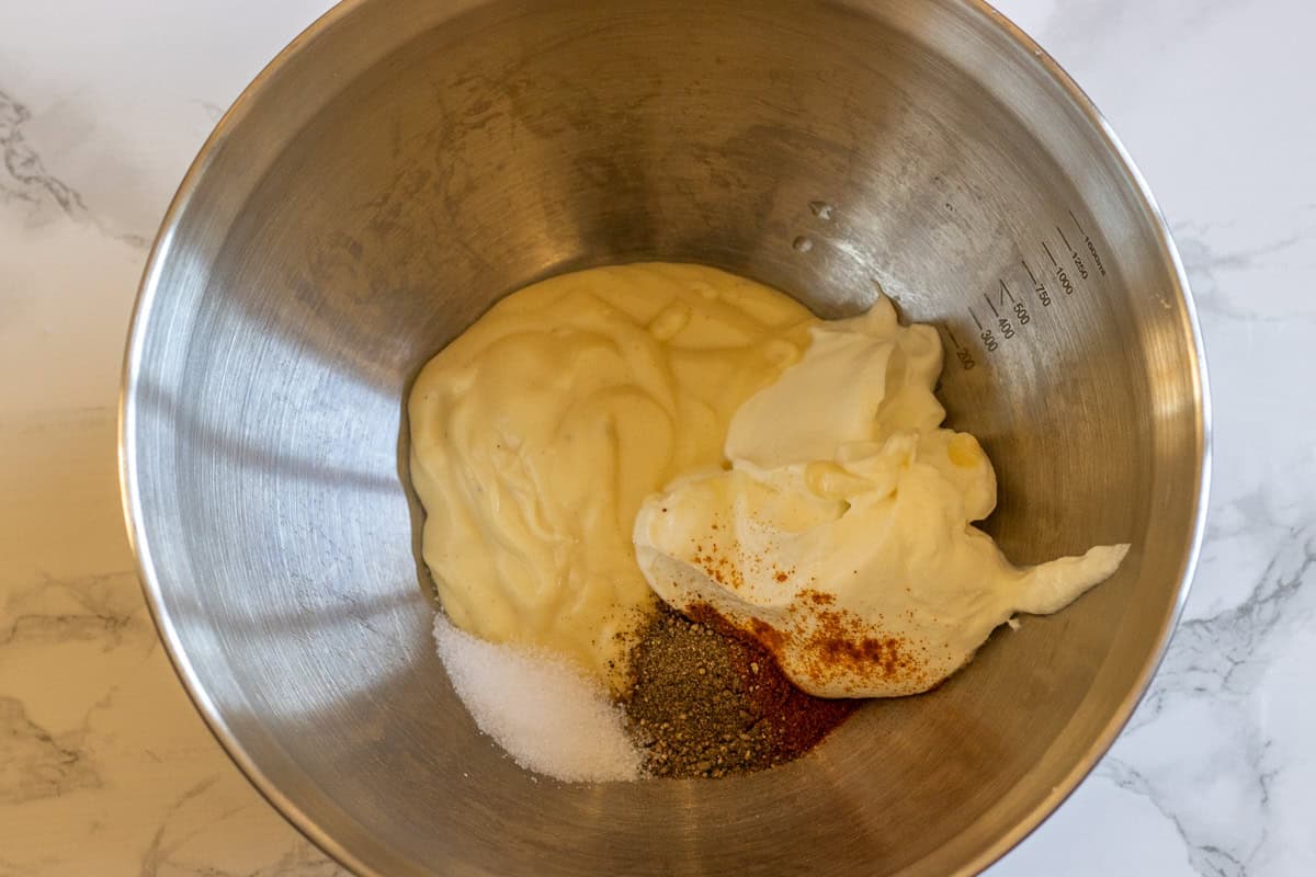 yogurt, mayonnaise, and seasoning are plavced in a bowl