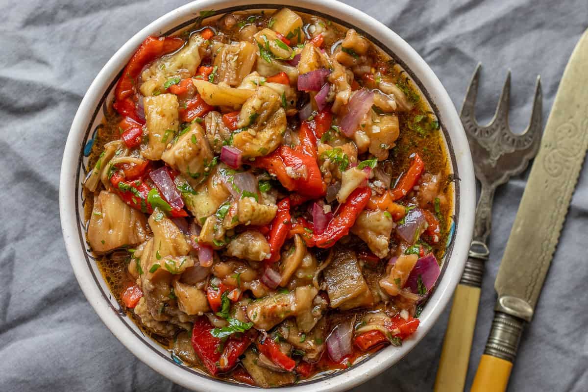 eggplant salad served in a bowl with cutlery 