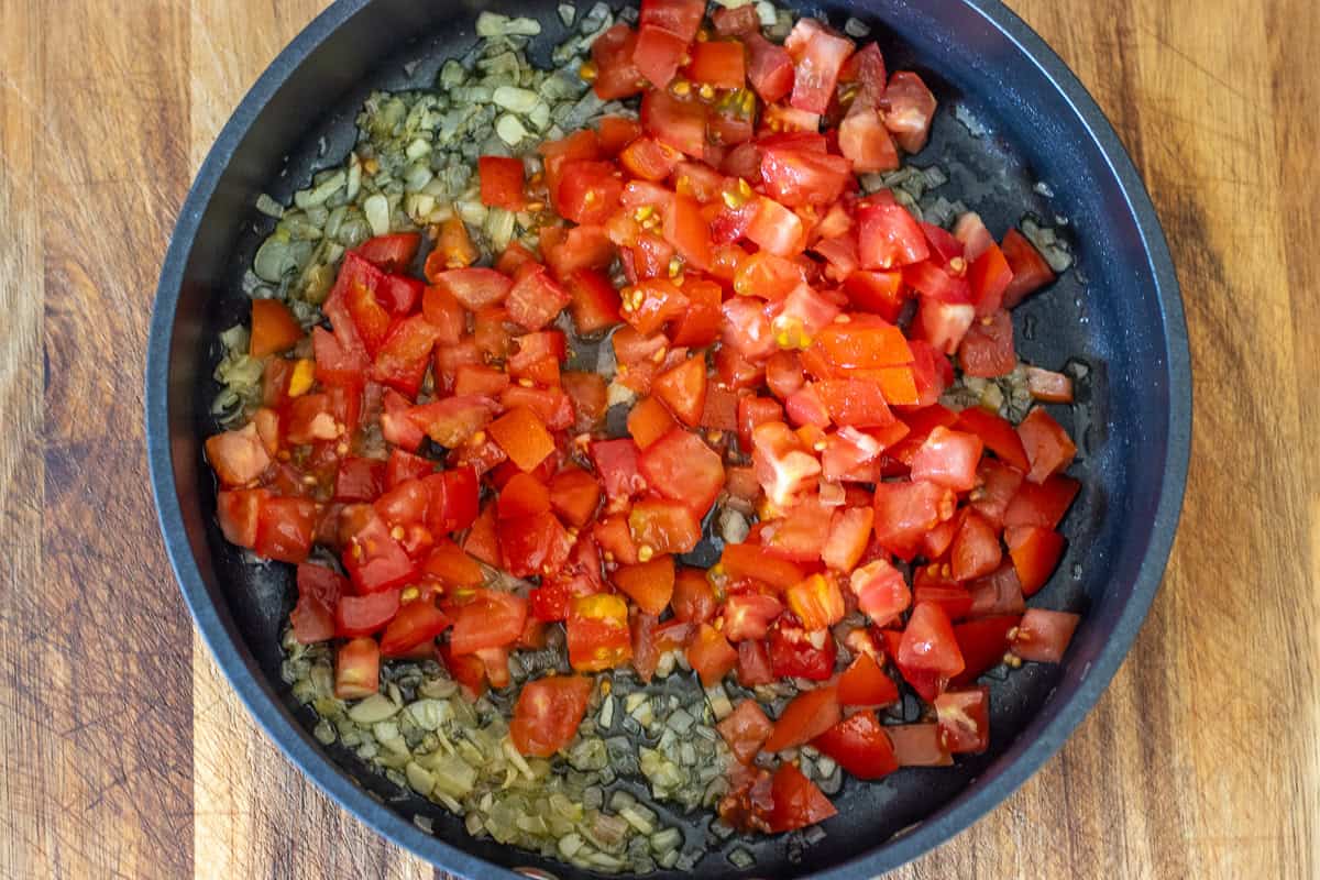 tomatoes are added to the pan