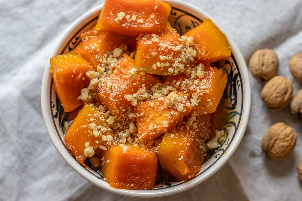 kabak tatlisi served in a bowl with walnuts
