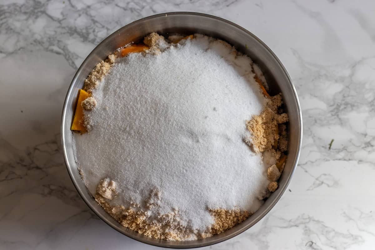 cut pumpkin pieces are covered with sugar