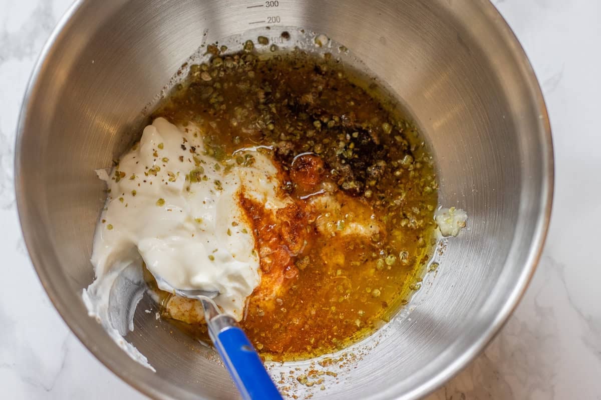 ingredients for greek chicken marinade are placed in a mixing bowl