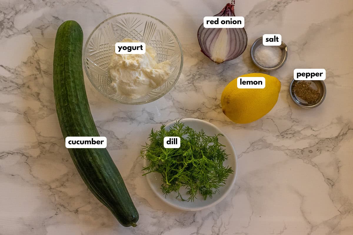 labelled picture of ingredients for creamy cucumber dill salad