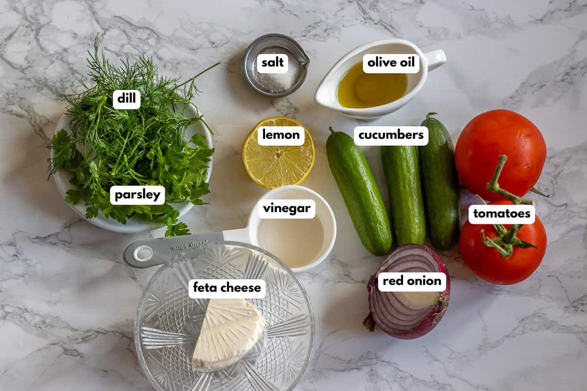 labelled picture of ingredients for cucumber tomato feta cheese salad