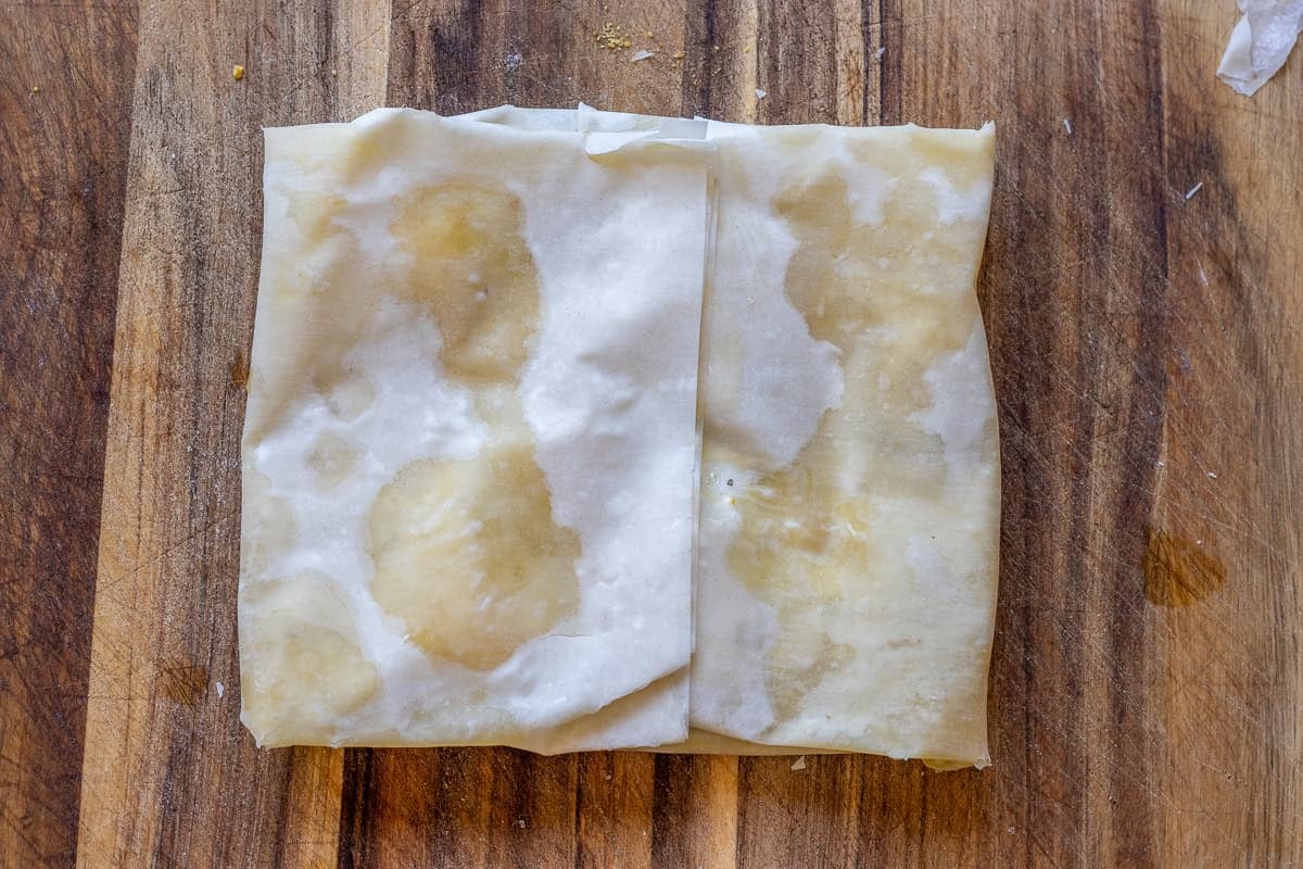 Folding the side of filo to create a square katmer.